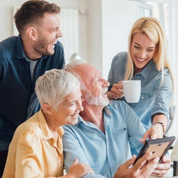 Multi-generational family smiling together at home